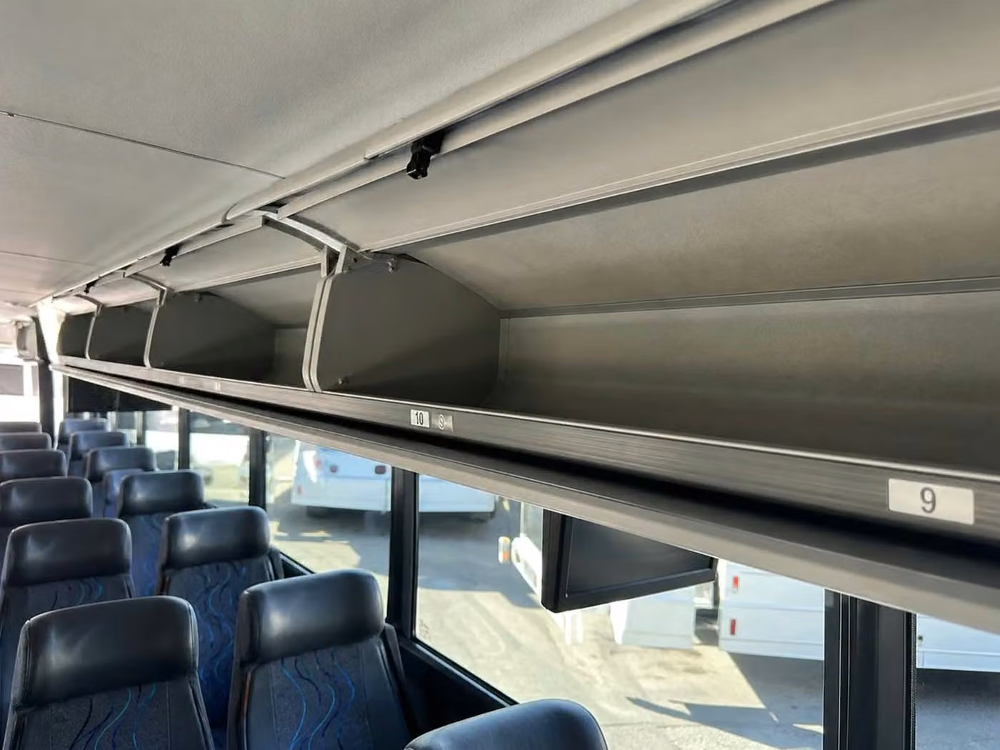 bell 56 passenger charter bus overhead storage